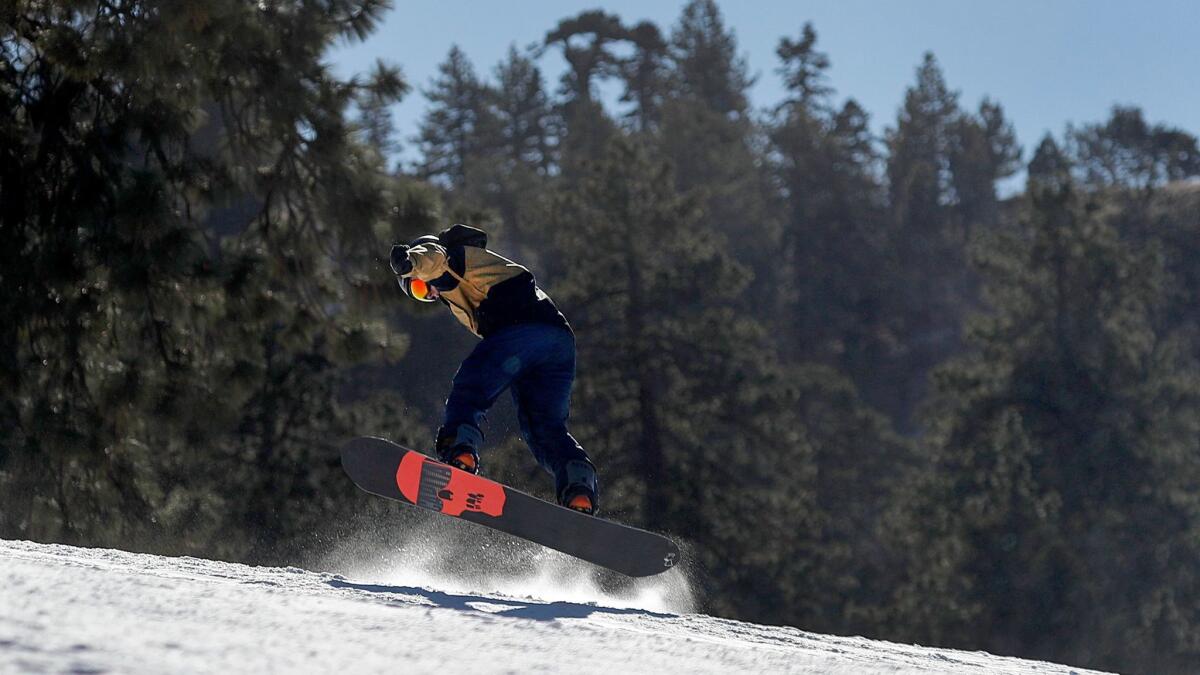 A snowboarder makes a jump at Mountain High resort in Wrightwood on Tuesday.