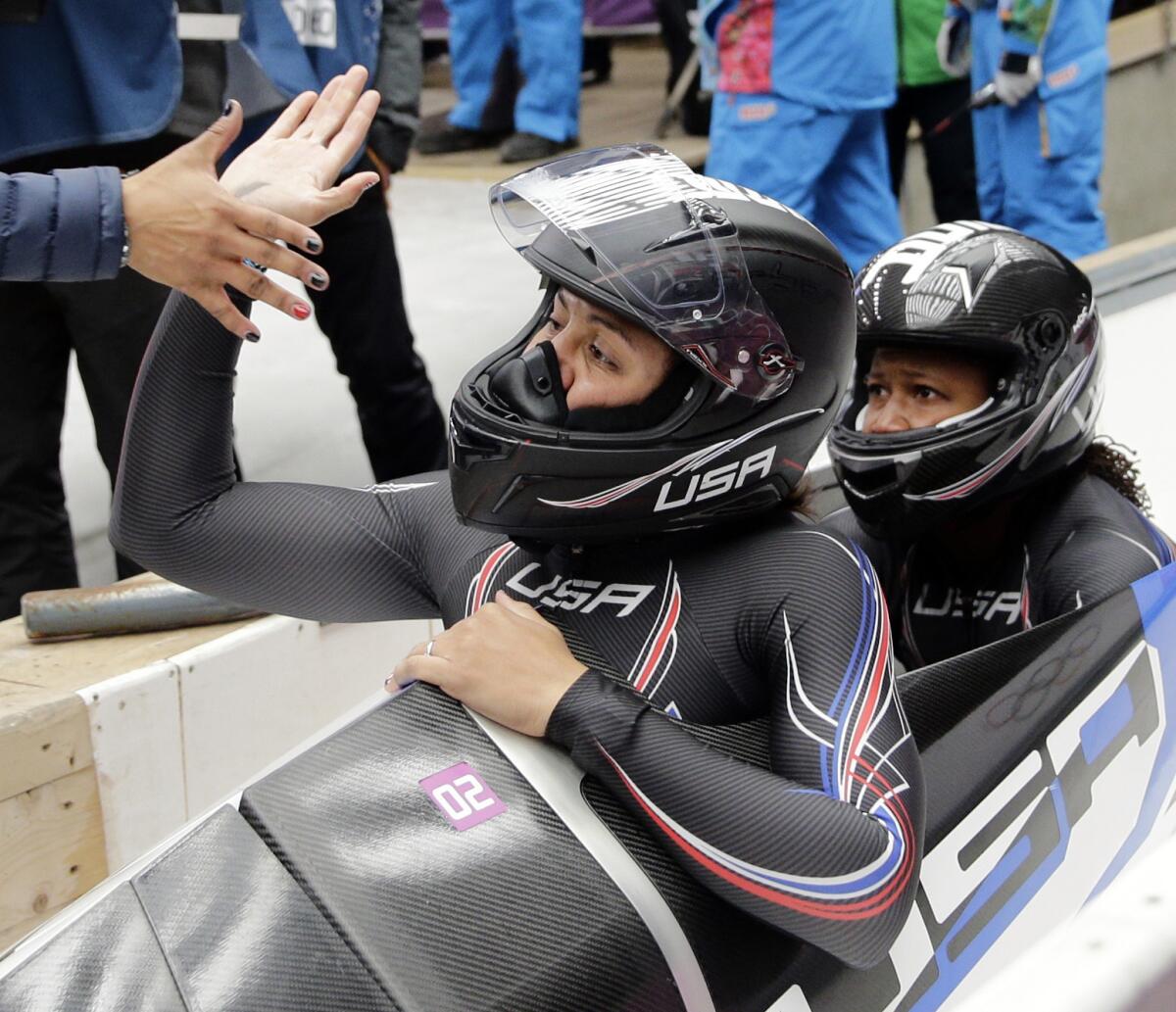 Elana Meyers Taylor, left, and brakeman Lauryn Williams are congratulated after their silver medal run at the 2014 Winter Olympics in February.