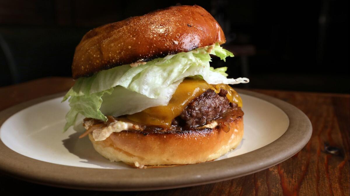 The Odys + Penelope burger is made with beef, cheddar cheese, onion jam and iceberg lettuce.