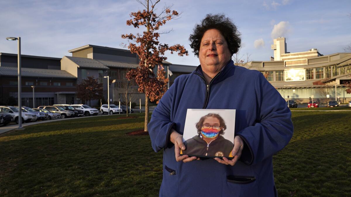 Laura Dilts holds a photograph of her 16-year-old son outside the Worcester Recovery Center, where he is a resident patient.