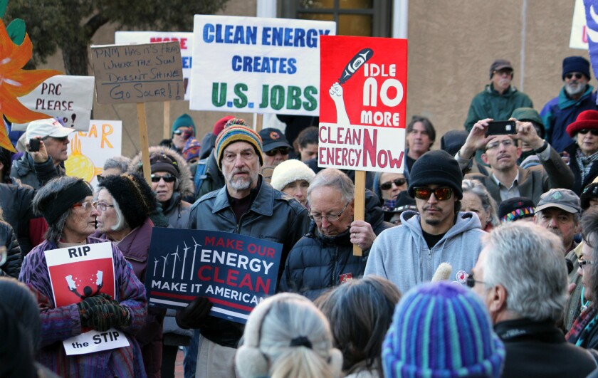Dozens rally in Santa Fe, N.M., in January as the New Mexico Public Regulation Commission considers a proposal to shut down part of a coal-fired power plant.