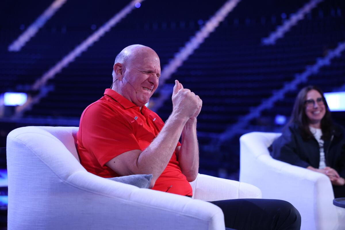 Clippers owner Steve Ballmer pumps his fists as he talks enthusiastically about the Intuit Dome's Halo Board on Friday.