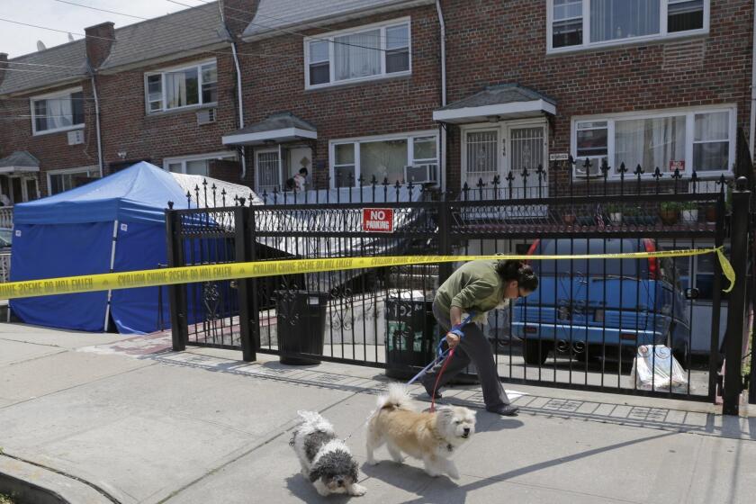 A woman ducks under crime scene tape in front of a New York city house once occupied by a famous gangster in New York on Tuesday. The work started Monday at the home of James Burke, a Lucchese crime family associate known as "Jimmy the Gent." He was the inspiration for Robert De Niro's character in the 1990 Martin Scorsese movie "Goodfellas." Burke died behind bars in 1996, two decades after authorities say he masterminded a nearly $6 million robbery at New York's Kennedy Airport, one of the largest cash thefts in American history. The Queens house is still owned by the Burke family, but others now live there.