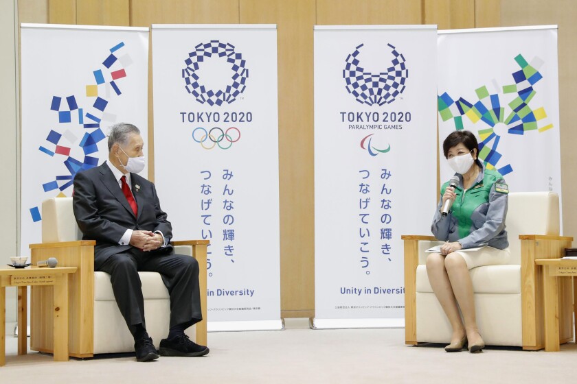Tokyo's newly reelected Gov. Yuriko Koike, right, meets Tokyo 2020 President Yoshiro Mori at Tokyo Metropolitan Government headquarters in Tokyo Monday, July 6, 2020. Koike assured Mori that she plans to continue working with him on achieving the games, and agreed to his proposal to set up a meeting among officials from the government, Tokyo and Olympic organizers to discuss COVID-19 countermeasures. (Kyodo News via AP)