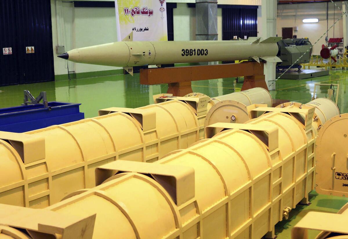 A yellow missile is displayed inside a building