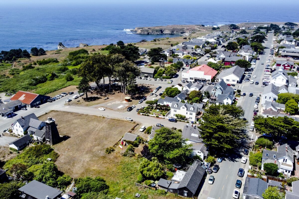 Aerial view of downtown Mendocino's homes and the coast of the Pacific Ocean