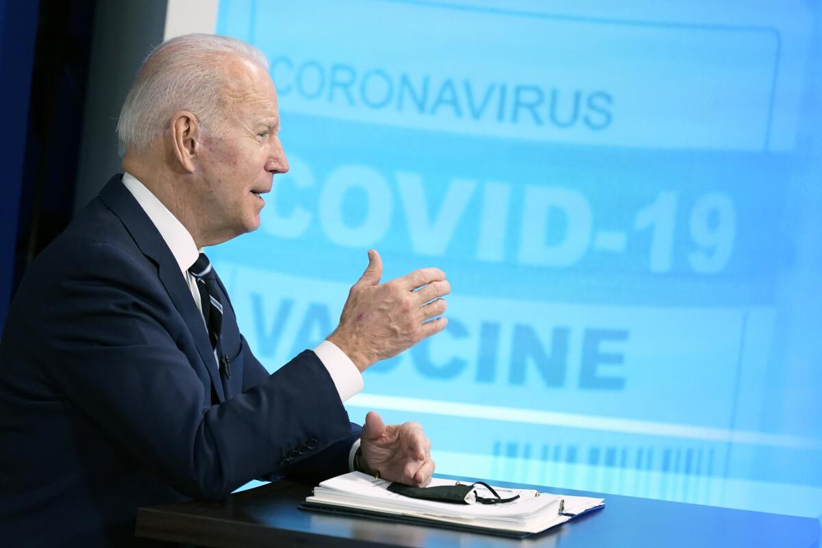 President Biden speaks before an image that says "Coronavirus -- COVID-19 vaccine"