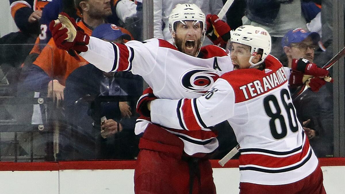 Carolina Hurricanes' Jordan Staal (11) in overtime against the New York Islanders and is joined by Teuvo Teravainen (86) in Game 1 of the Eastern Conference second round during the NHL playoffs on Friday.