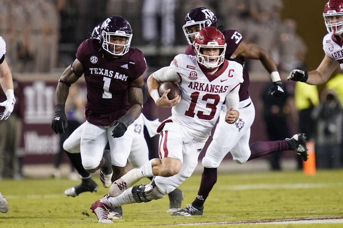 Arkansas quarterback Feleipe Franks (13) rushes for a first down against Texas A&M during the first quarter of an NCAA college football game Saturday, Oct. 31, 2020, in College Station, Texas. (AP Photo/Sam Craft)