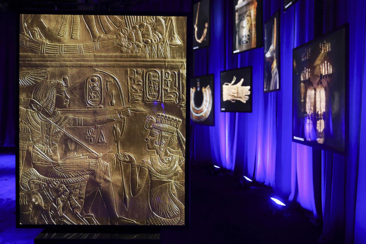 Photos of artifacts found in King Tut's tomb are displayed at the King Tut Immersive Experience