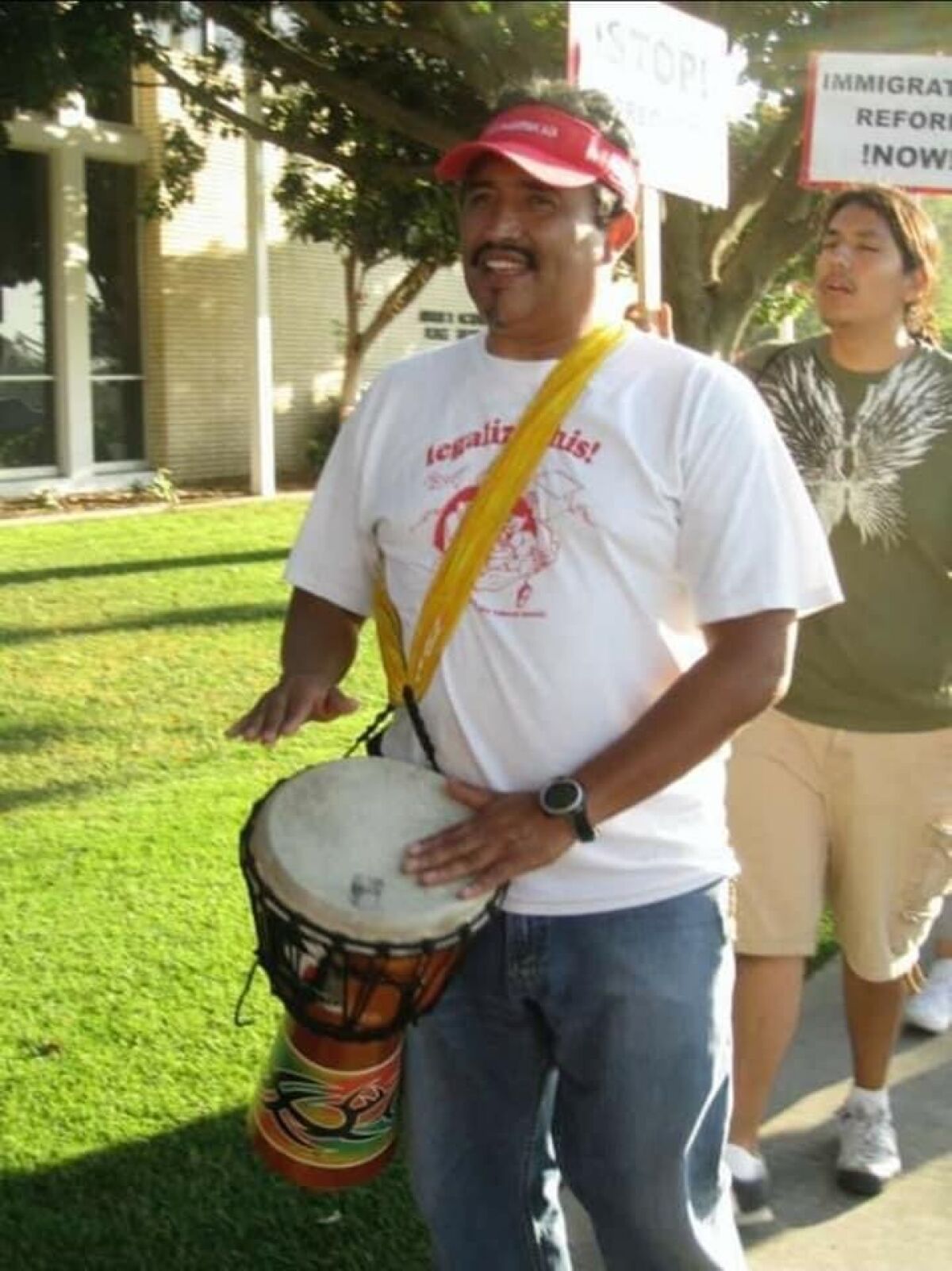 Antonio Bernabe bangs on a djembe.
