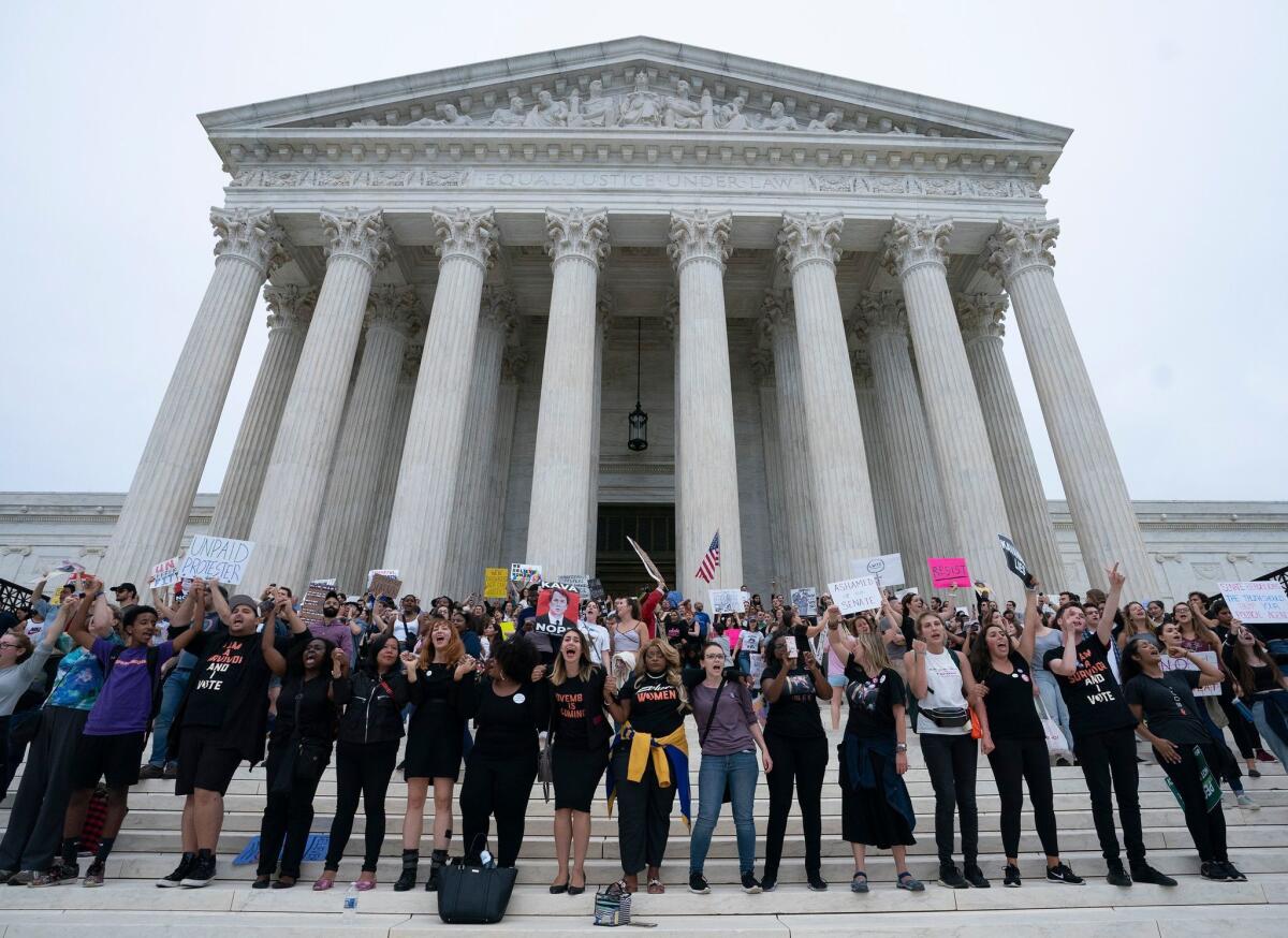 Immigration advocates rally outside the Supreme Court in Washington.