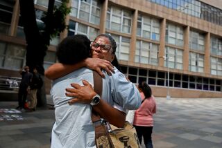 RIO DE JANEIRO, BRAZIL - SEPTEMBER 13: Ialode (cq) Charmite, 30, left, gives Glaucia dos Santos, 46, a hug in front of the Central Forum - Court of Justice of the State of Rio de Janeiro (TJRJ) on Tuesday, Sept. 13, 2022 in Rio de Janeiro, Brazil. dos Santos along with other mothers and family members, hold a protest rally wanting justice for her son Fabricio dos Santos, 17, who was gunned down by two police officers at a gas station in the Chapadao favela in 2014, and other victims. Glaucia was to appear in court to testify as a character witness for Fabricio. The officers are on trial and each face seven years in prison if convicted of both murder and fraud for having planted a gun on Fabricio. A lawyer for one of the defendants did not show up. The judge postponed the trial until April of next year. Guilherme Pimentel, 38, of Rio de Janeiro, ombudsman of the Public Defender's Office of Rio de Janeiro, helps disenfranchised people with gaining access to file human rights violation complaints and to pressure the public prosecutor to bring charges against the police who commit acts of violence. When there is a police raid on a favela, Pimentel goes in to monitor it. There is an epidemic of police killings in Rio de Janeiro, a city of 7 million where last year more people were killed by law enforcement than in the entire United States. (Gary Coronado / Los Angeles Times)
