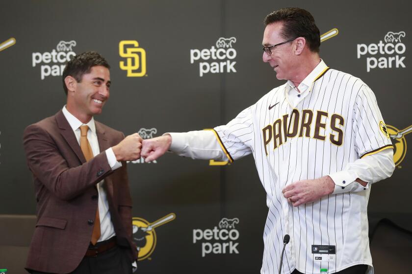 SAN DIEGO, CA - NOVEMBER 1: Padres general manager A. J. Preller fist bumps Bob Melvin, who was introduced as the Padres manager at Petco Park on Monday, Nov. 1, 2021 in San Diego, CA. (K.C. Alfred / The San Diego Union-Tribune)