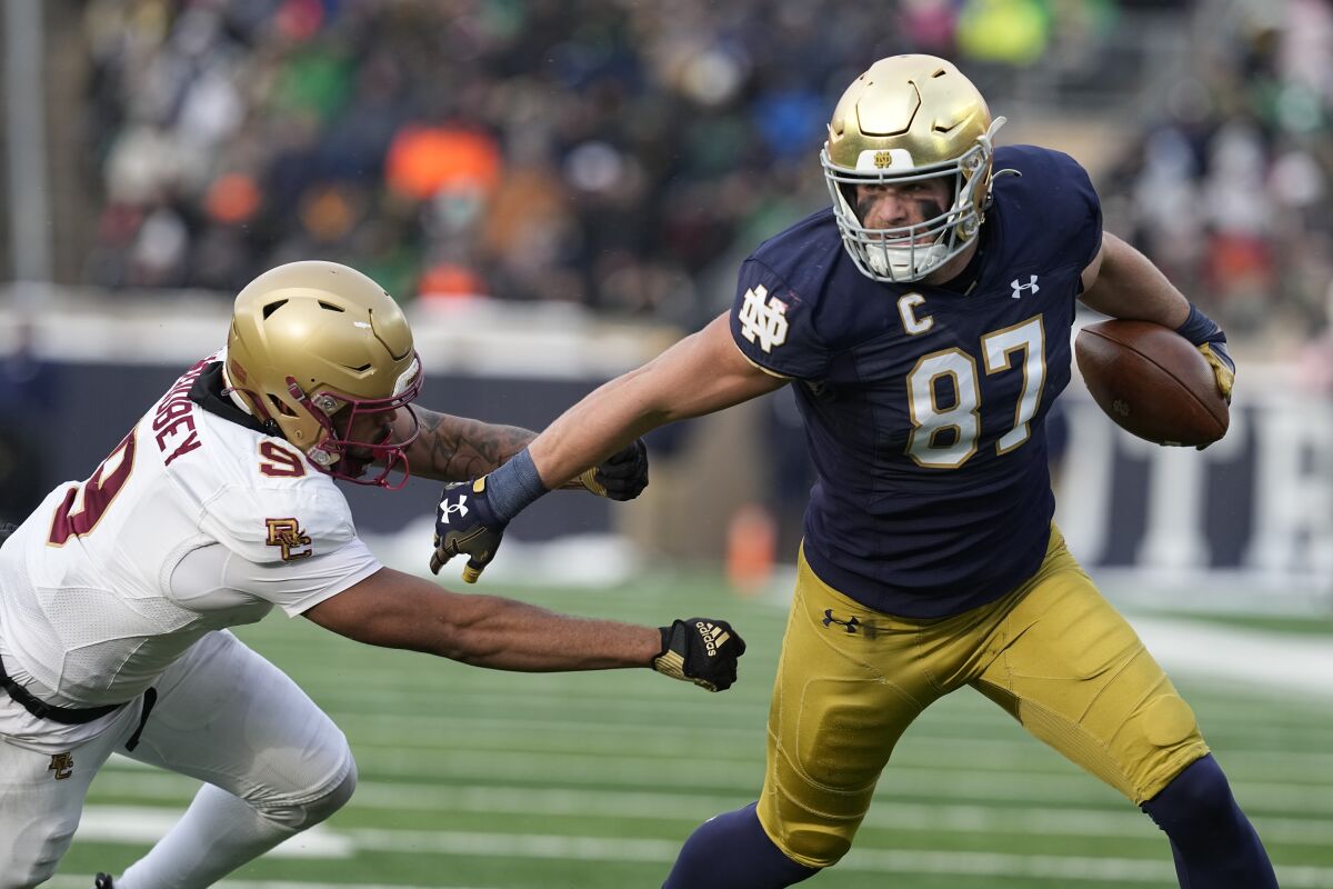 Notre Dame tight end Michael Mayer runs past Boston College defensive back Jaiden Woodbey.