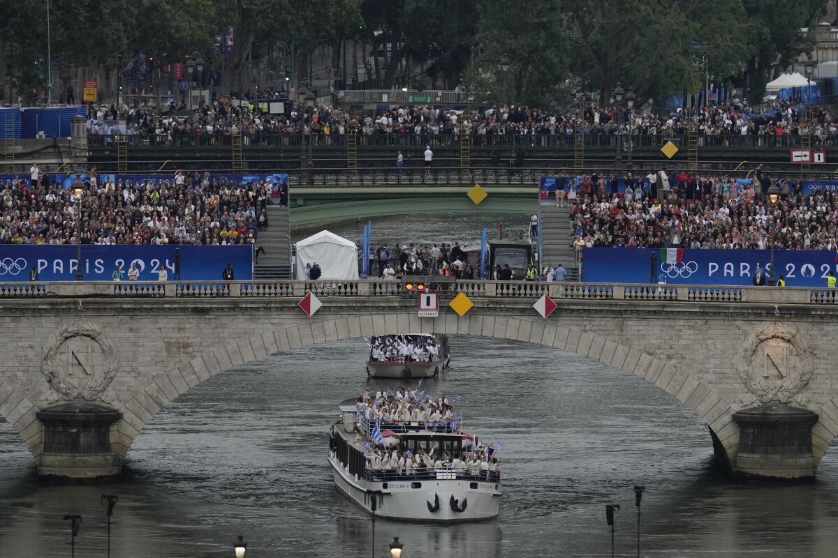 Team Greece travels by boat along the Seine during the Olympics opening ceremony.
