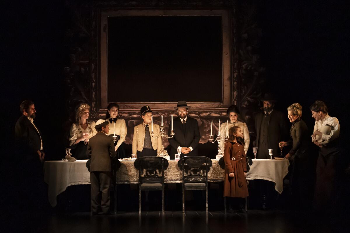 A Jewish family gathers around a long dining table by candlelight.