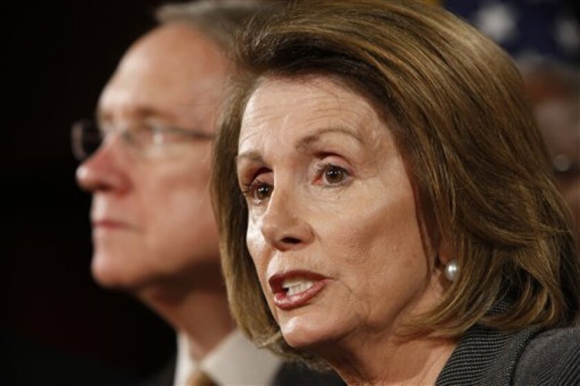 House Speaker Nancy Pelosi of Calif., right, accompanied by Senate Majority Harry Reid of Nev. takes part in a news conference on the auto industry bailout, with fellow congressional leaders, Thursday, Nov. 20, 2008, on Capitol Hill in Washington. (AP Photo/Gerald Herbert)