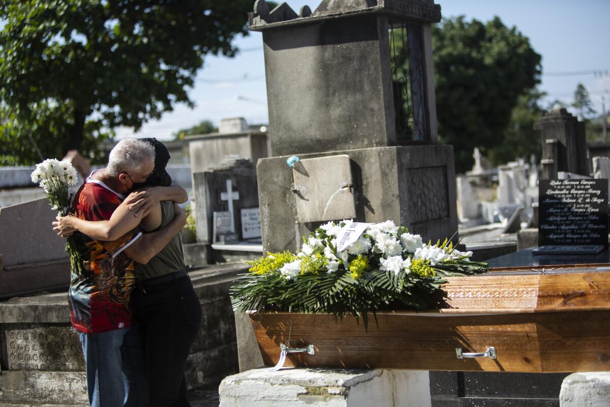 Relatives grieve during the burial service