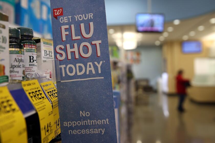 A sign advertising flu shots is displayed at a Walgreens Pharmacy in Concord, Calif. Public health officials are encouraging residents to get flu shots as an aggressive strain of the H1N1 "swine flu" has killed nearly 100 people in California so far this season.