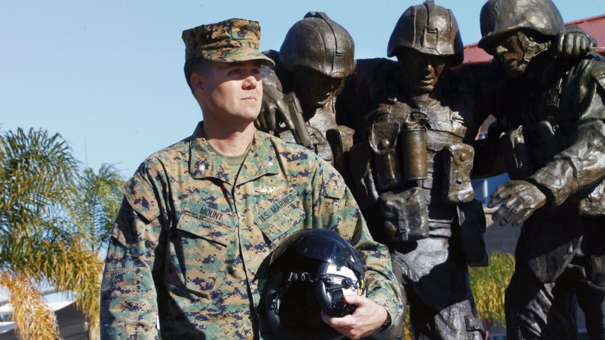 Lt. Col. Stephen "Slade" Mount, holding the flight helmet he wore when he was wounded in 2004, is now commander of Wounded Warrior Battalion West at Camp Pendleton.