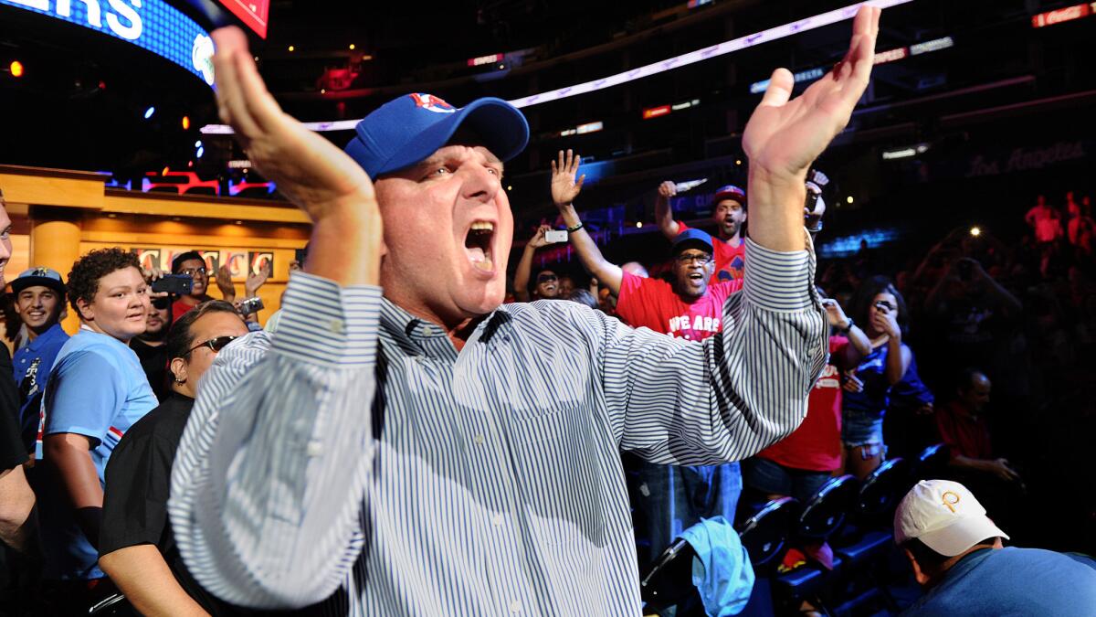 New Clippers owner Steve Ballmer cheers as he greets fans during a rally at Staples Center on Monday.