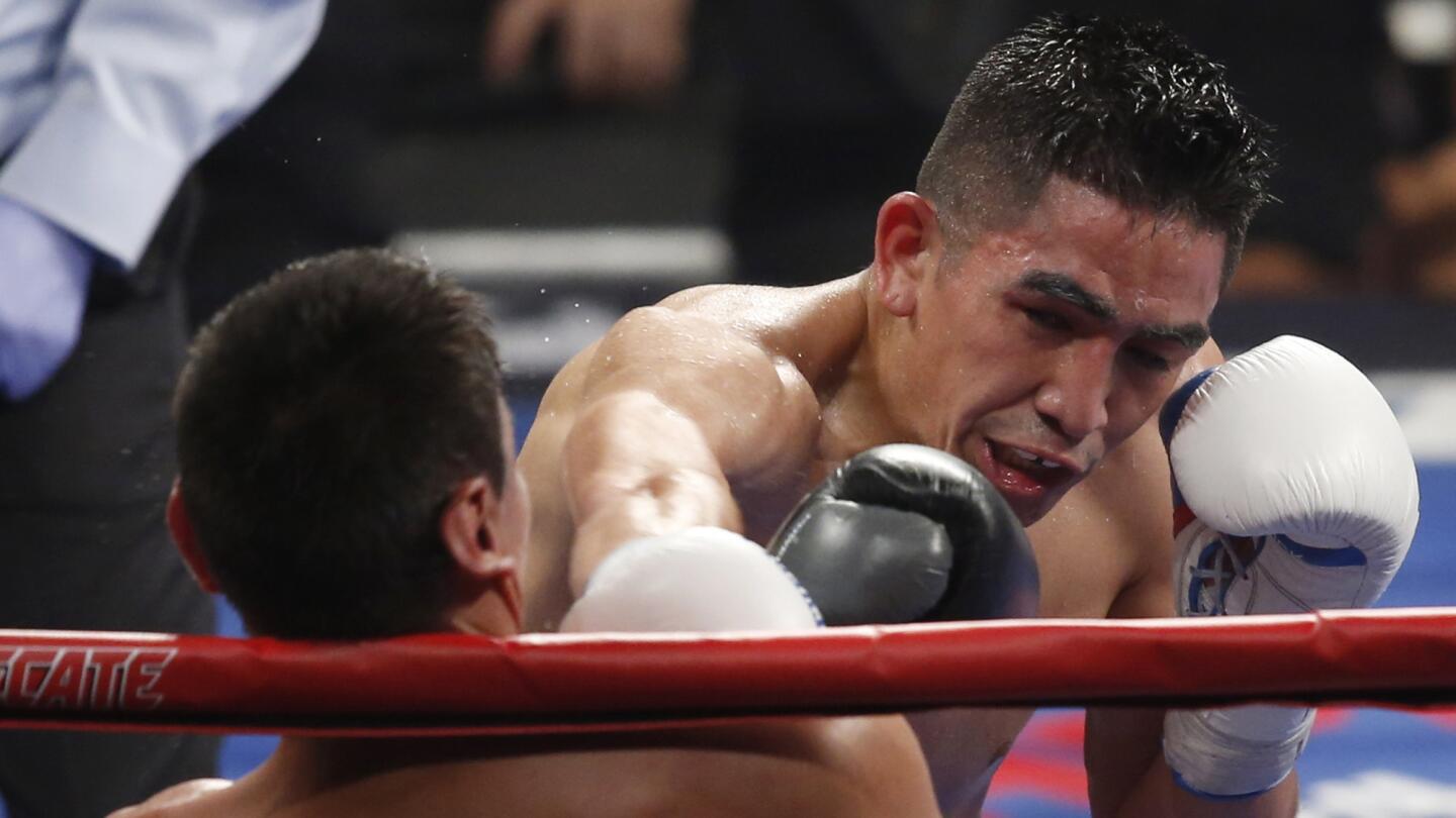 Leo Santa Cruz, right, punches Jose Cayetano during their featherweight fight at MGM Grand in Las Vegas on May 2, 2015.