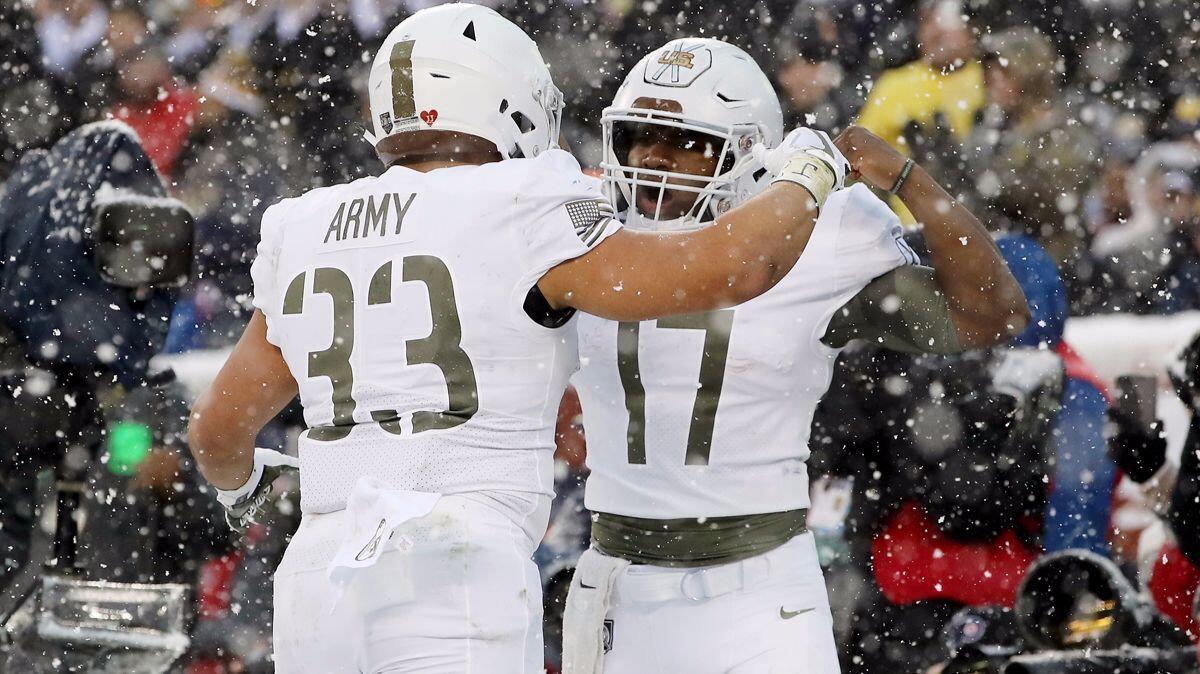 Army's Darnell Woolfolk (33) celebrates his touchdown with teammate Ahmad Bradshaw (17) in the first half against Navy Midshipmen on Dec. 9 at Lincoln Financial Field in Philadelphia.
