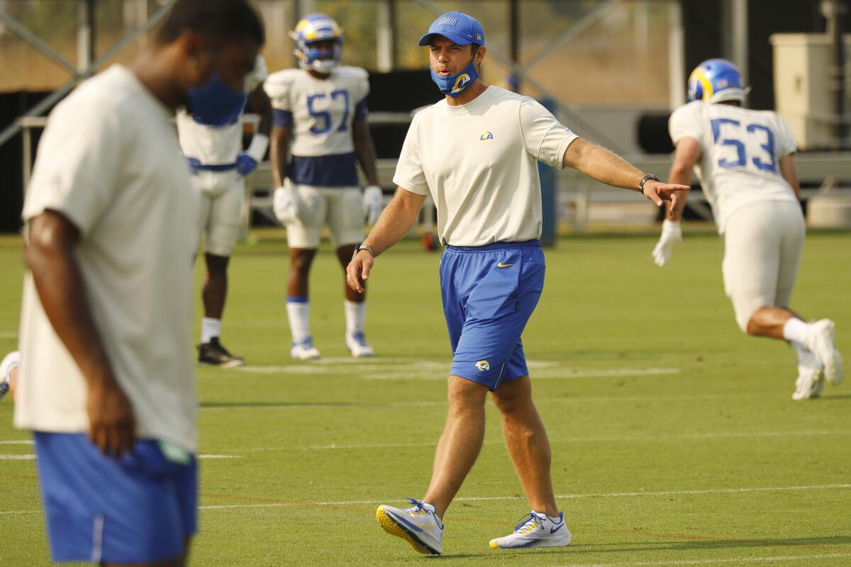 Rams defensive coordinator Brandon Staley works with players as the team conducts practice.