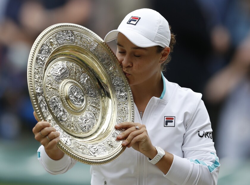 FILE - Australia's Ashleigh Barty poses with the trophy for the media after winning the women's singles final after defeating the Czech Republic's Karolina Pliskova on day twelve of the Wimbledon Tennis Championships in London, Saturday, July 10, 2021. Wimbledon champion Ash Barty finished No. 1 in the WTA singles rankings for the third consecutive season, while Katerina Siniakova topped the doubles rankings for the second time. Barty, a 25-year-old from Australia, joins Serena Williams, Steffi Graf, Martina Navratilova and Chris Evert as the only women to lead the year-end tennis rankings three straight times. (Pete Nichols/Pool via AP, File)