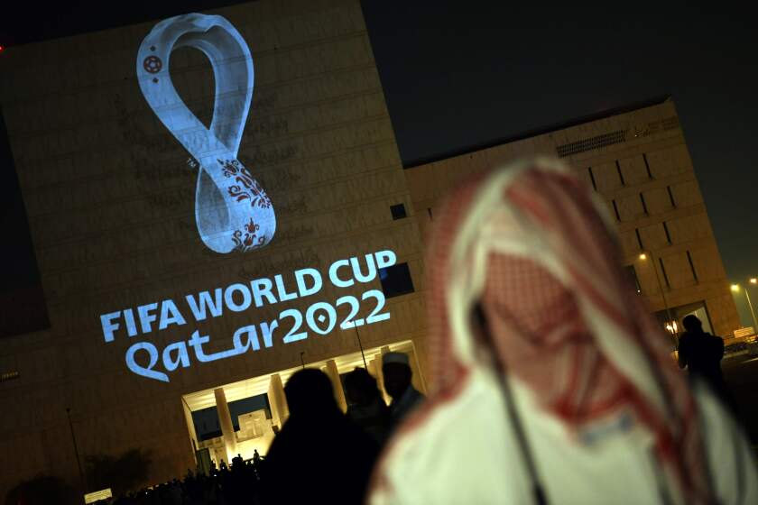 People gather at the capital Doha's traditional Souq Waqif market while the official logo of the FIFA World Cup Qatar 2022 is projected on the front of a building on September 3, 2019. (Photo by - / AFP)-/AFP/Getty Images ** OUTS - ELSENT, FPG, CM - OUTS * NM, PH, VA if sourced by CT, LA or MoD **