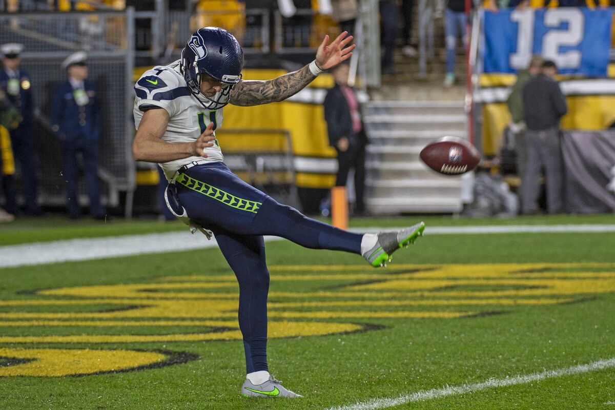 FILE - Seattle Seahawks punter Michael Dickson (4) warms up before an NFL football game against the Pittsburgh Steelers, Sunday, Oct. 17, 2021, in Pittsburgh. In this era of increased offensive potency and data-driven decisions, NFL teams are going for it on fourth down far more than they used to. That means the already overlooked position of punter has become even less of an asset on a roster, despite the favorable rules and strong legs around the league capable of consistently producing big kicks. (AP Photo/Justin Berl, File)