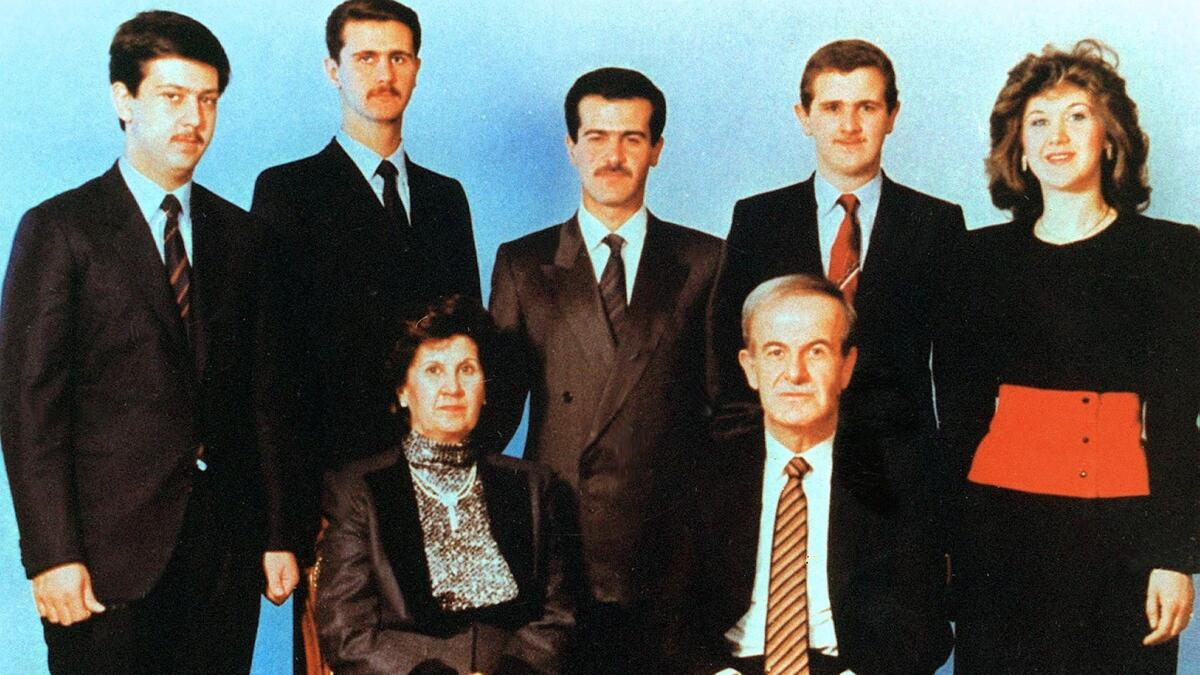 Undated picture shows then-Syrian President Hafez Assad and his wife, Anisseh, posing for a family picture with their children, Maher, from left, Bashar (Syria's current president), Bassel, Majd and Bushra.