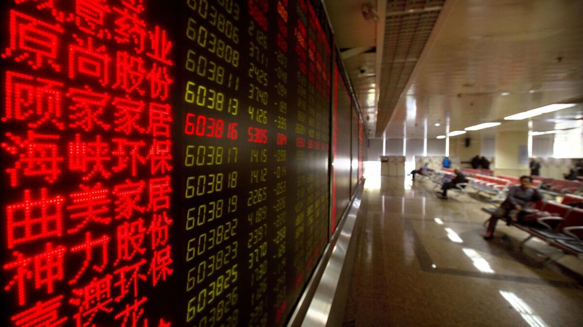 Chinese investors monitor stock prices at a brokerage house in Beijing on Tuesday, Nov. 7, 2017.