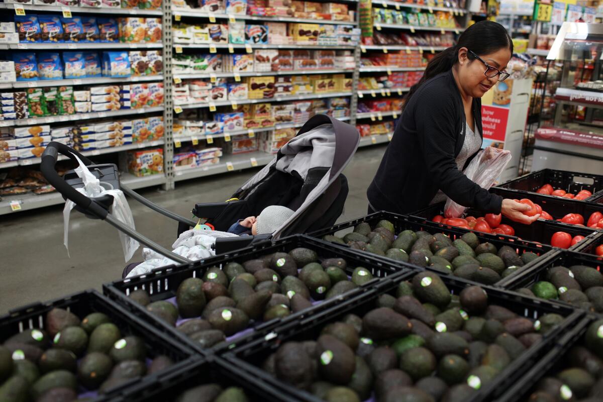 Miriam Bautista goes shopping for fruits and vegetables in Los Angeles. (Dania Maxwell / Los Angeles Times)