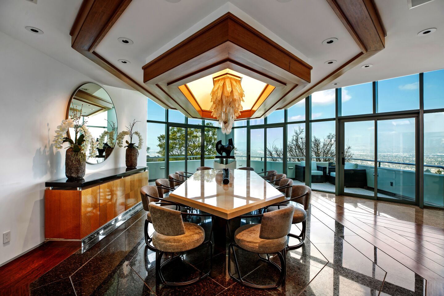 Pharrell's glass mansion has a dining room with a crystal rock chandelier.