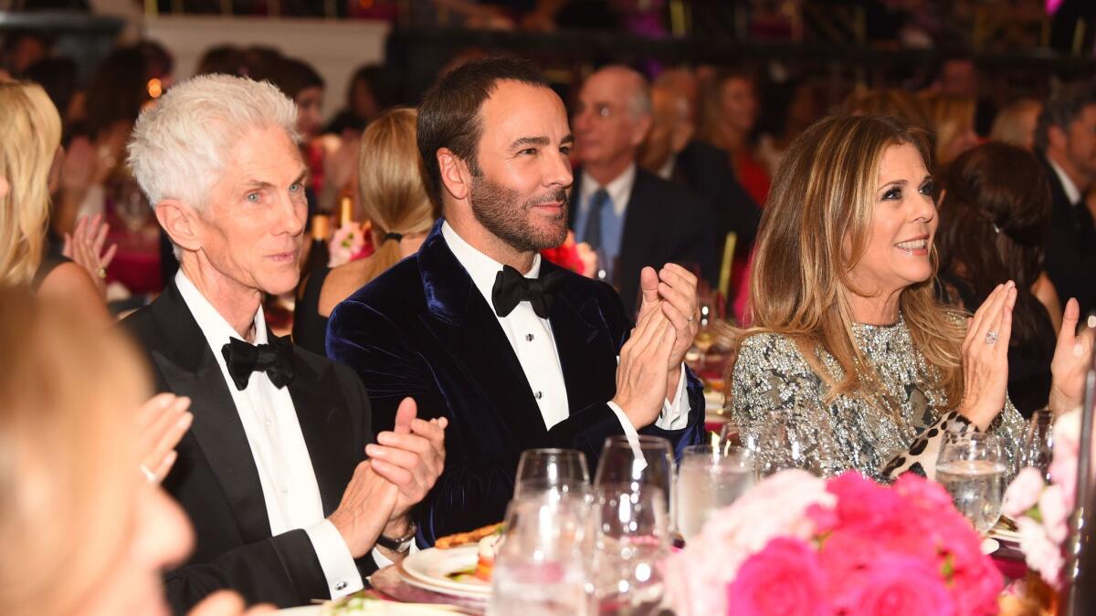 Richard Buckley, left, honoree Tom Ford and honorary co-chair Rita Wilson sit together at An Unforgettable Evening on Feb. 16 in Beverly Hills.