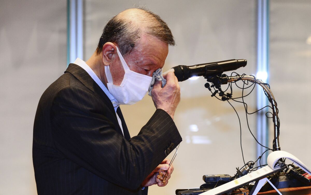 Hong Won-sik, chairman of Namyang Dairy Products, wipes his tears during a press conference at the company's headquarters in Seoul, South Korea, Tuesday, May 4, 2021. Hong resigned over a scandal in which his company was accused of deliberately spreading misinformation that its yogurt helps prevent coronavirus infections. (Hwang Gang-mo/Yonhap via AP)