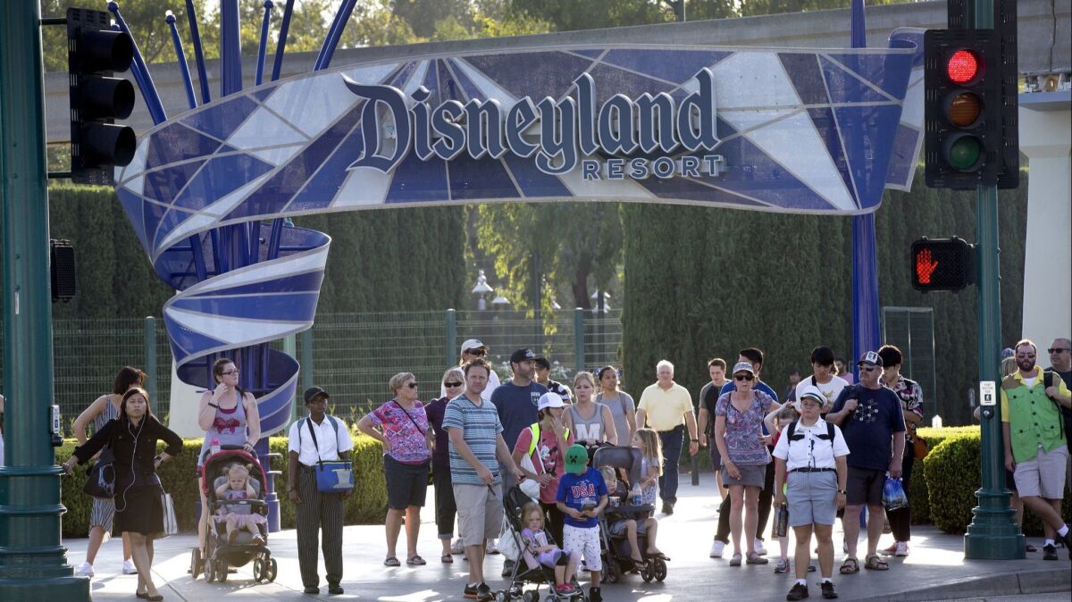 Disneyland patrons exit the theme park in 2017. The resort plays a big role in the politics of Anaheim.
