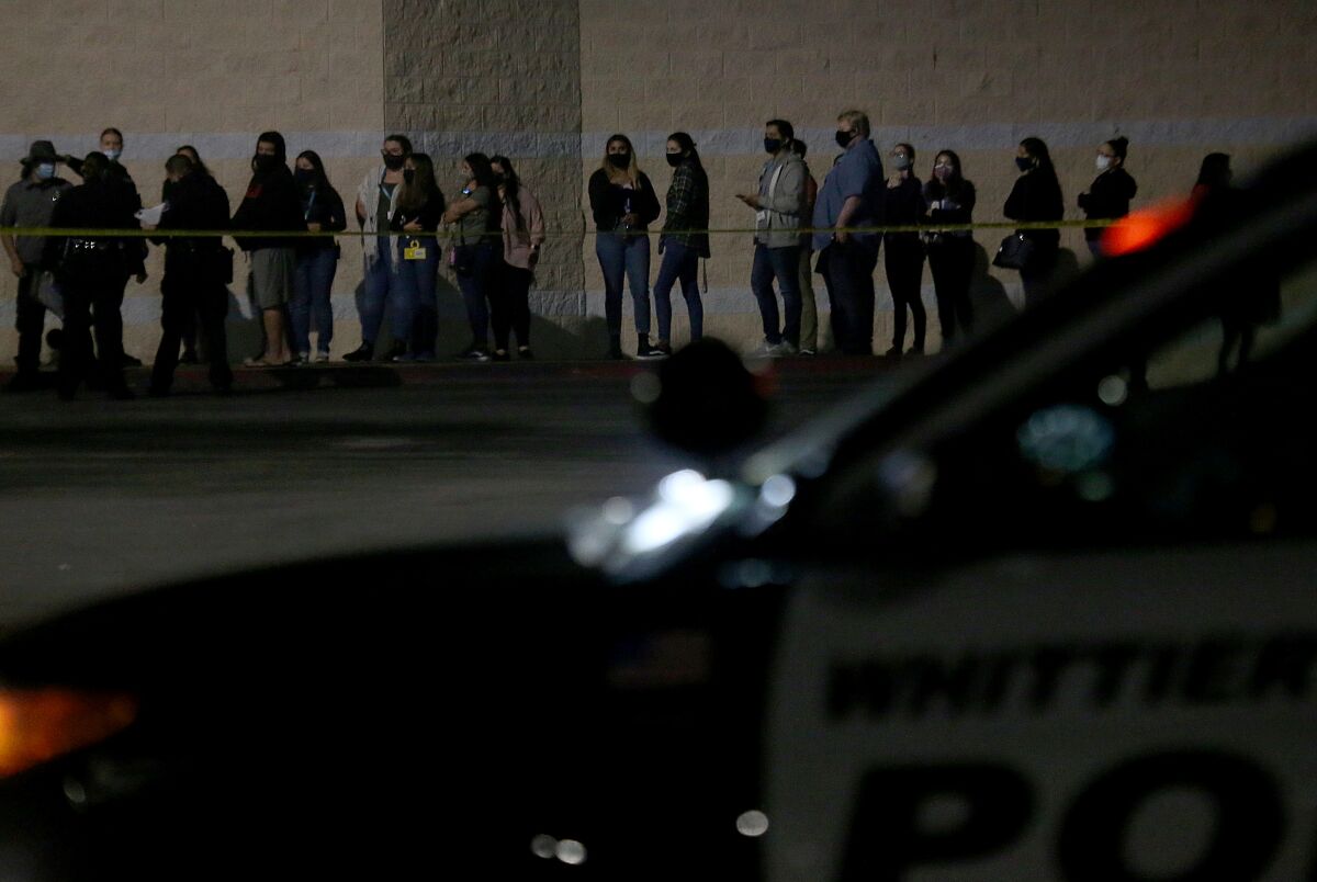 Store employees stand outside the Kohl's  in Whittier, where a shooting resulted in a fatality