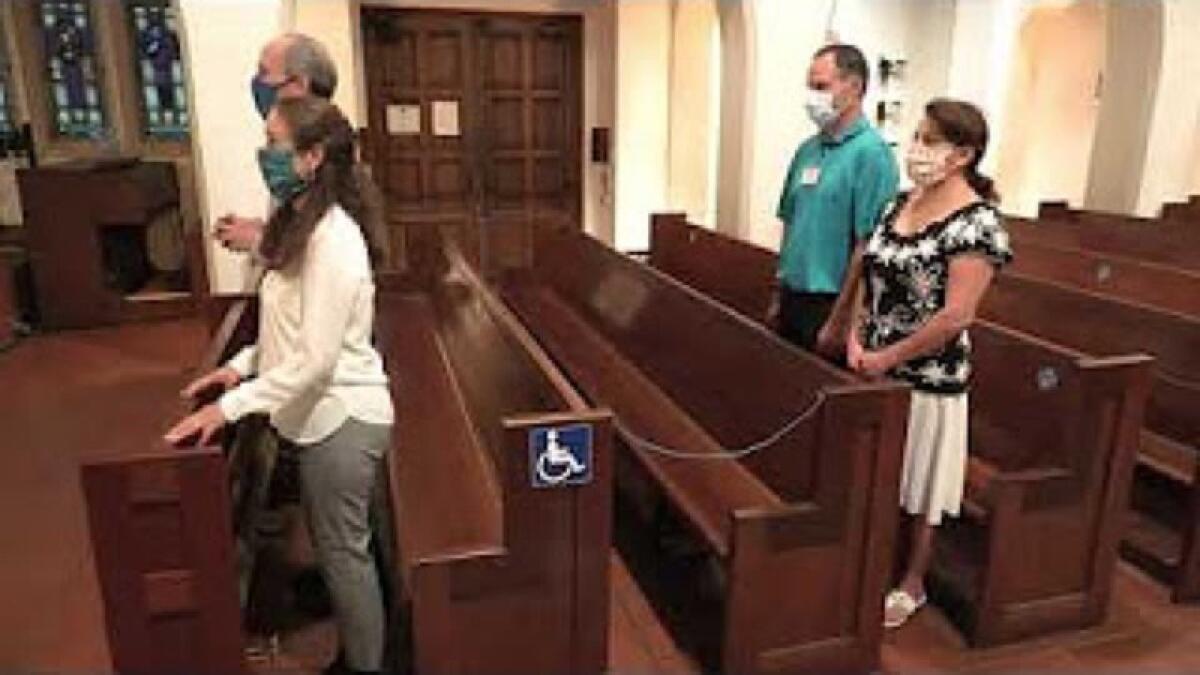 Sacred Heart Church of Ocean Beach demonstrates mask and distancing requirements for Mass in a video posted on YouTube.