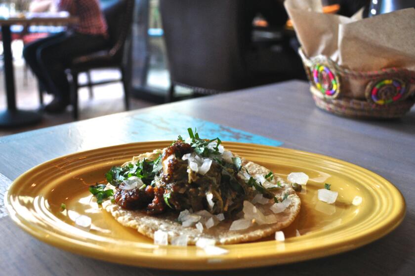 A chile verde carnitas taco is among the many tacos offered at Pez Cantina.