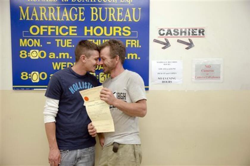 William Roletter, left, and Paul Rowe, with their newly acquired marriage certificate at Philadelphia City Hall on Wednesday.