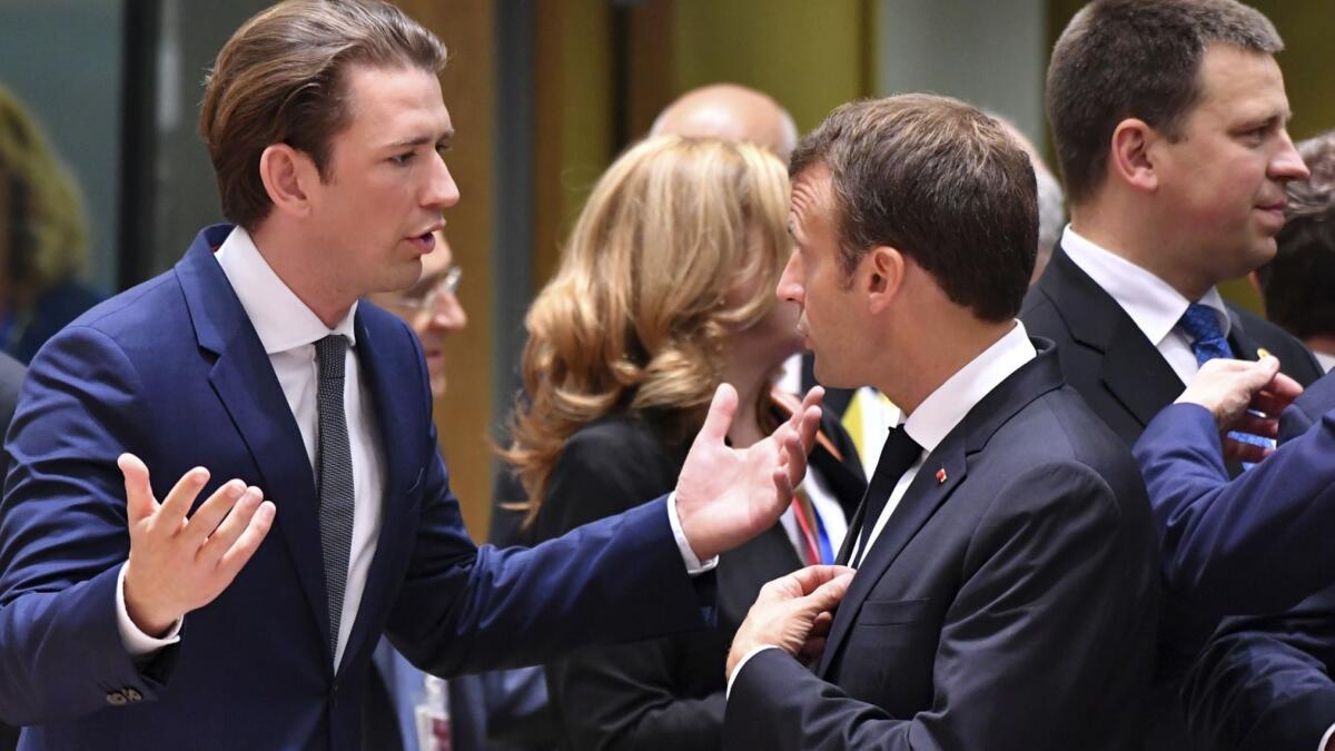 Austrian Chancellor Sebastian Kurz, left, speaks with French President Emmanuel Macron at an EU summit in Brussels on June 28.