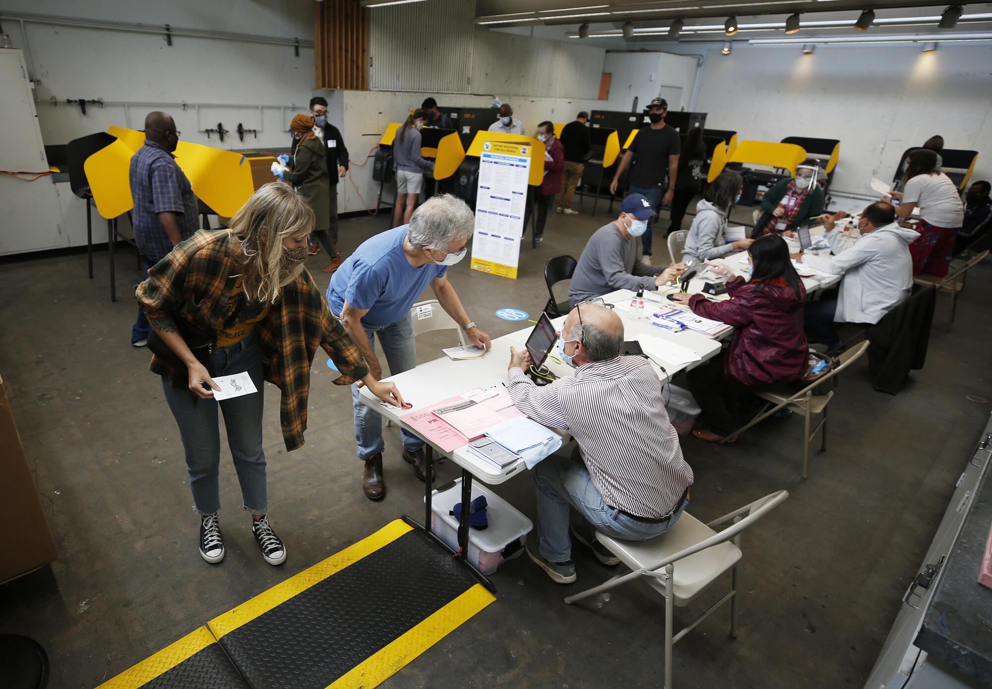 Voters check in with poll workers 