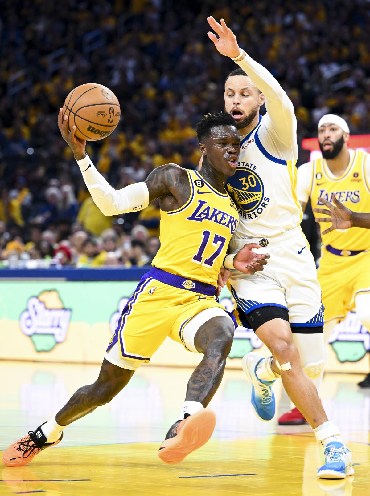 Lakers guard Dennis Schroder drives down the lane against Warriors guard Stephen Curry in Game 5.
