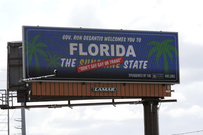 A new billboard welcoming visitors to "Florida: The Sunshine 'Don't Say Gay or Trans' State. is seen Thursday, April 21, 2022, in Orlando, Fla. Billboards, which are being placed in key areas with high visitor traffic and visibility, are part of a new advertising campaign launched by the Human Rights Campaign (HRC). (AP Photo/John Raoux)
