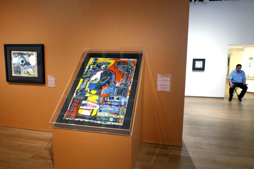 Paintings on display by artist Jean-Michel Basquiat are seen at the Orlando Museum of Art in Orlando, Fla. in 2022.