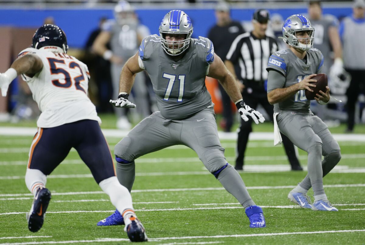 FILE - This Nov. 28, 2019, file photo shows Detroit Lions offensive tackle Rick Wagner (71) blocking for quarterback David Blough, right, against Chicago Bears outside linebacker Khalil Mack (52) during the second half of an NFL football game in Detroit. Wagner, now an offensive tackle for the Green Bay Packers, has a tough assignment as he returns to his home state. The West Allis native and former Wisconsin lineman is getting the first shot to emerge as Green Bay’s right tackle, a spot where Bryan Bulaga had been a fixture for a decade before signing with the Los Angeles Chargers. (AP Photo/Duane Burleson, File)