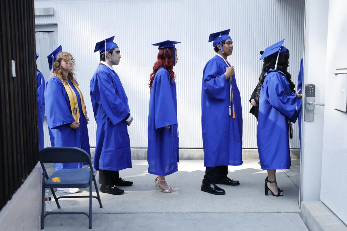 Students wait in line to go on stage.